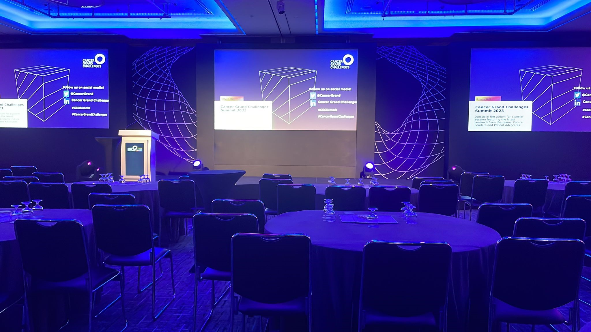A conference stage, screens and lighting produced by White Label